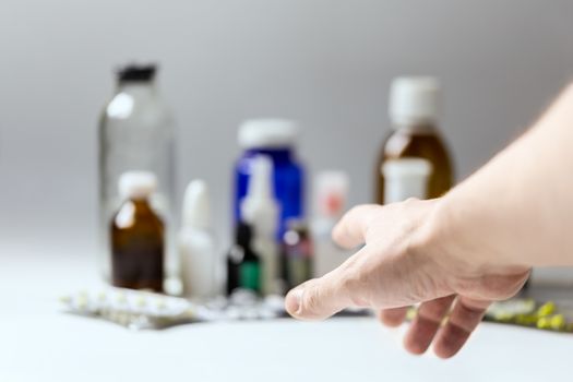 right hand reaching for meds with selective focus and shallow depth of field.