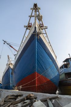 The bow of a huge old wooden boat, built in the traditional way, in the port of the city of Jakarta. Used to transport all kinds of merchandise between the islands.