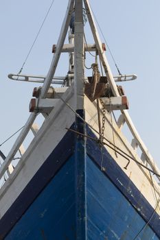 The bow of a huge old wooden boat, built in the traditional way, in the port of the city of Jakarta. Used to transport all kinds of merchandise between the islands.