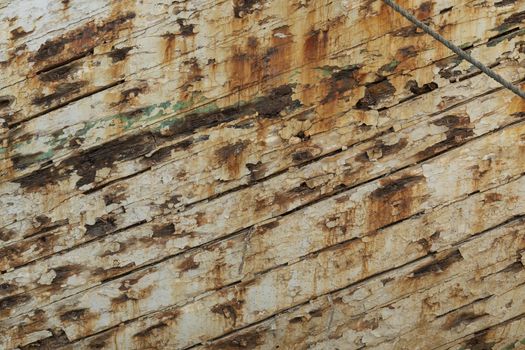 Grunge wood background with white peeling paint, from an old ship in Indonesia.