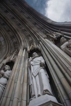 Photograph of carved arch with statues. Catholic Temple