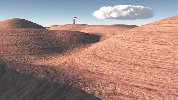 Man with red umbrella stands in rocky desert
