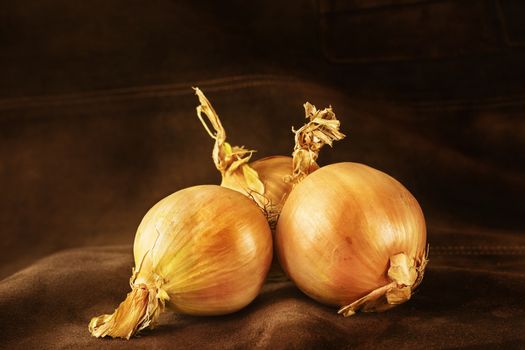 Brown onions on dark brown background ,whole common onions ,