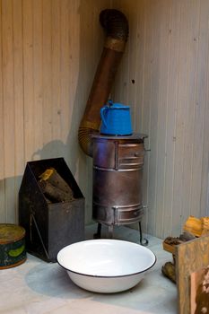 Old vintage heating equipment closeup photo with basin and fireplace