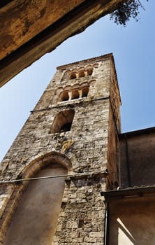 Medieval bell tower of Saint Andrew church in Anagni Italy along a narrow alley,beautiful three-mullioned windows ,