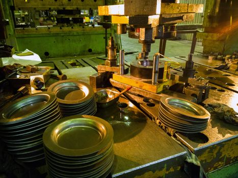 Dirty used low tech stamping press producing round aliminium parts. Selective focus technicque.