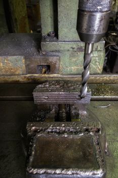 old drilling machine with obsolete used vice with selective focus.