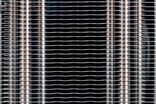 Abstract heat radiator closeup. Modern tower heat sink with heatpipes inside closeup macro background with selective focus and horizontal composition.
