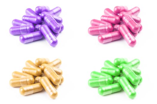 set of of colored organic capsules isolated on white background closeup with selective focus.
