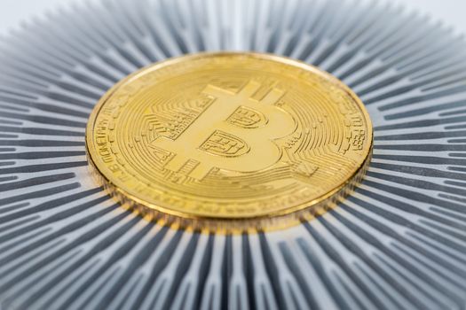 physical bitcoin symbol close-up on aluminium heatsink with selective focus