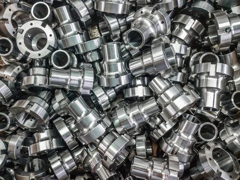 Shiny metal car parts background with selective focus under direct sunlight. Factory new condition.