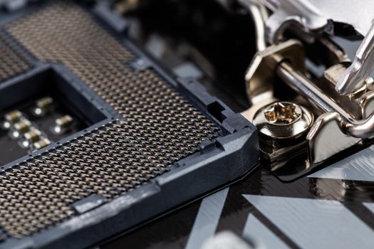 opened central processor land grid array slot on pc mainboard - closeup shot with selective focus and blur
