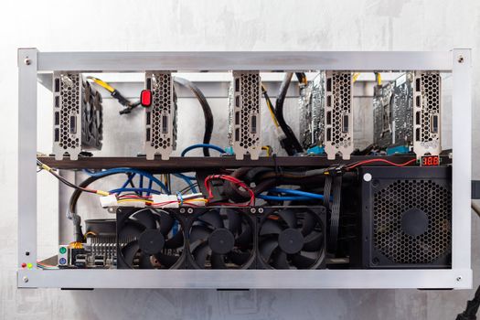 domestic gpu cripto mining rig on wall with selective focus.