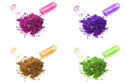 opened colored organic med capsule isolated on white background closeup.