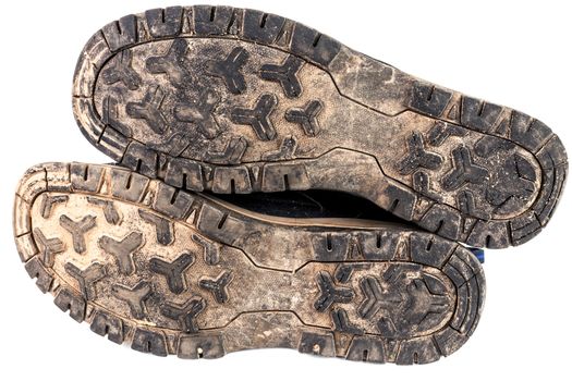 dirty used worn out black outdoor sneakers sole isolated on white.