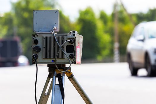 mobile speed camera device working on summer daytime road with selective focus - back side