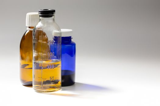 colored medial bottles on gray background with copyspace.