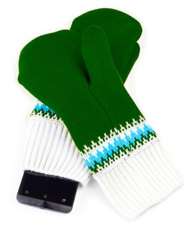 green and white knited mittens with cellphone isolated on white background.