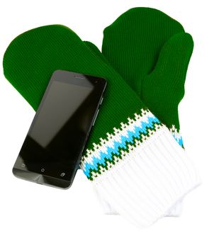 green and white knited mittens with cellphone isolated on white background.