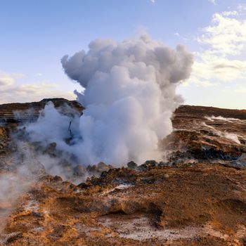 Geothermally active valley with geysir at Iceland
