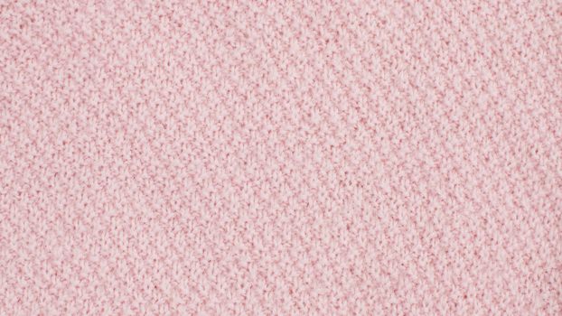 Extreme close up pink wool knitted fabric. Texture, textile background. Macro shooting