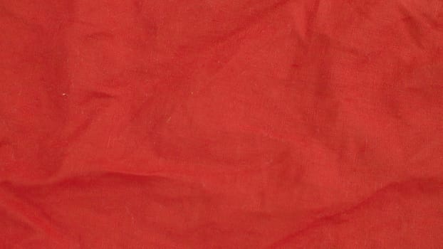 Extreme close up - red linen cloth. Texture, textile background. Macro shooting, camera slowly moving along the cloth on slider.