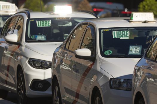 Madrid, Spain - May 19, 2020: Taxis of the private public taxi service of the city of Madrid, in service, on O'Donnell street, in the central district of Retiro.