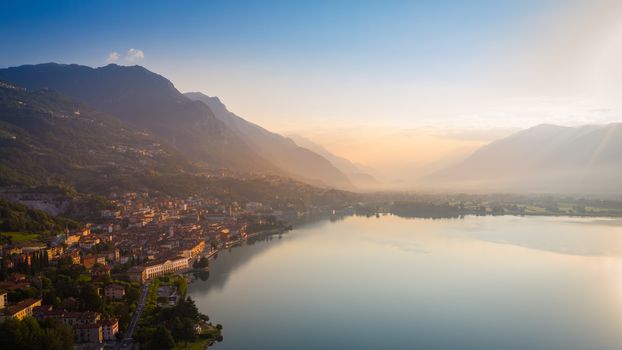 Aerial view of Lake Iseo at sunrise, on the left the city of lovere which runs along the lake,Bergamo Italy.