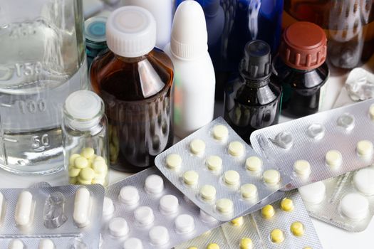 bunch casual of half-used and opened medial bottles and tablets with selective focus.