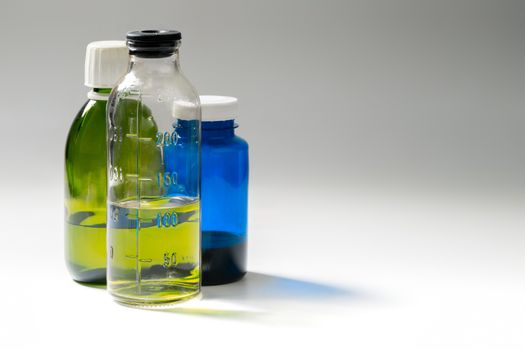colored medial bottles on gray background with copyspace.