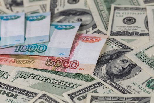 russian rubl and us dollar banknotes close-up with selective focus and blur