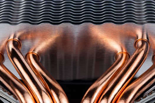modern tower heat radiator with six copper heatpipes close-up macro background with selective focus and blur.