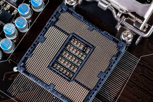 opened central processor land grid array slot on pc mainboard - closeup shot with selective focus and blur