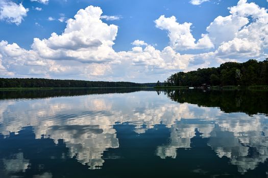 reflection of clouds in the waters of Lake Chycina during summer in Poland