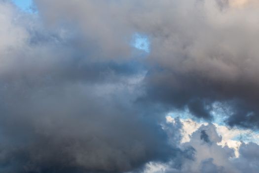grey incoming storm clouds at evening closeup backdrop