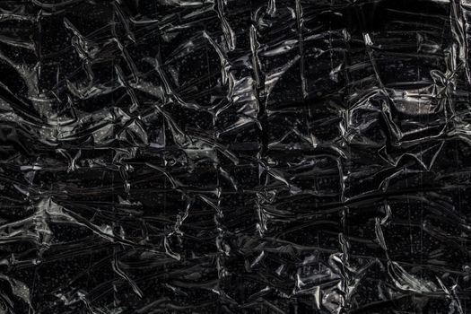 black polyethilene film enforced by sticky tape flat smuggle package texture and background