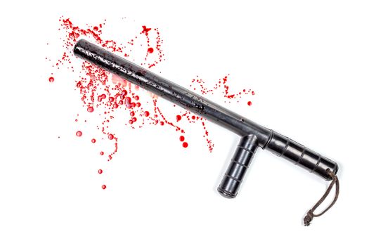 Bloody russian police rubber tonfa baton in blood spatter isolated on white background in top-down flat lay perspective. Natural human blood used.