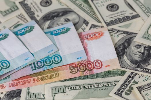 russian rubl and us dollar banknotes close-up with selective focus and blur