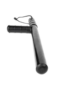 Black classic rubber police tonfa baton isolated on white background with selective focus and wide angle perspective.