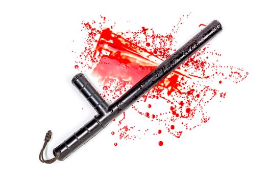Bloody russian police rubber tonfa baton in blood spatter isolated on white background in top-down flat lay perspective. Natural human blood used.
