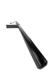 Black classic rubber police tonfa baton isolated on white background with selective focus and wide angle perspective.
