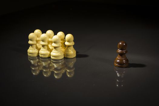 Chess pieces on a black reflective surface
