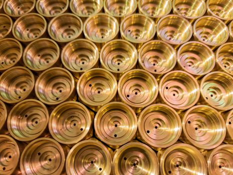 an abstract perspective industrial close-up background of shiny brass metal threaded hexagonal fitting parts.