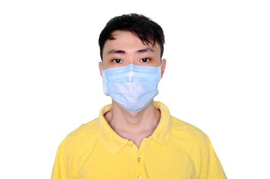 Young asian man in yellow t-shirt wearing medical mask, isolated on white background. Coronavirus or covid-19 protection concept.