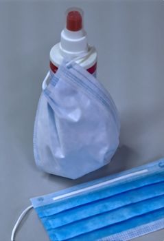 Corona face mask and disinfection spray on an office desk