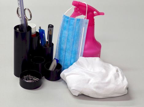 Corona face mask and disinfection spray on an office desk