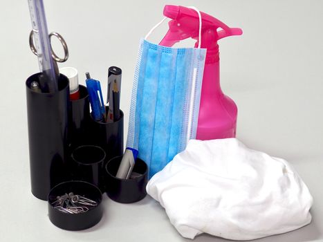 Corona face mask and disinfection spray on an office desk