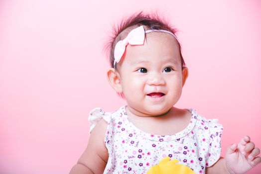 Portrait of Asian girl little cute baby smiling happy face on pink background