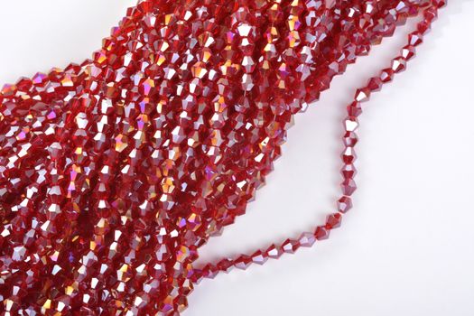 Beautiful Red scarlet, ruby Glass Sparkle Crystal Isoalted Beads on white background. Use for diy beaded jewelry. Space for text