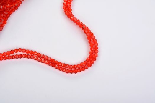 Beautiful Red scarlet, ruby Glass Sparkle Crystal Isoalted Beads on white background. Use for diy beaded jewelry. Space for text